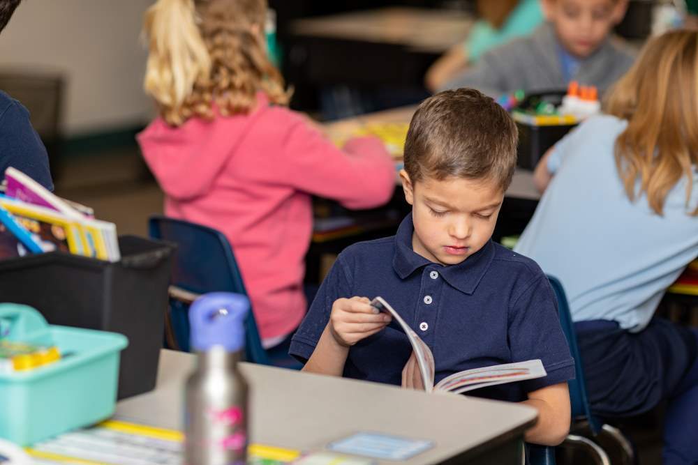 Twin Peaks Classical Academy tuition-free charter school student reading a book at his desk