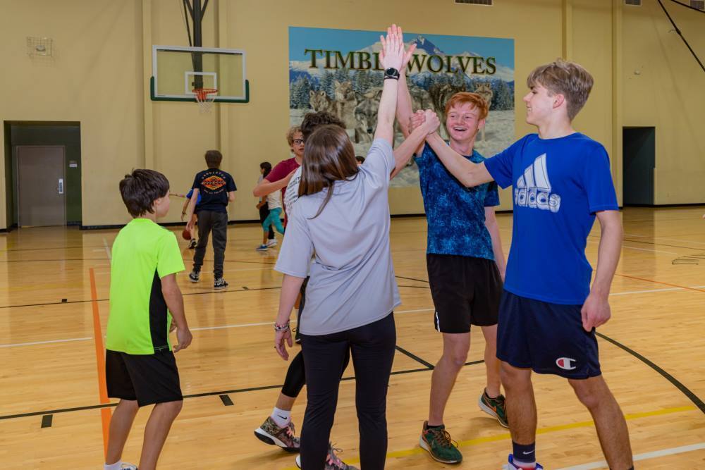 Twin Peaks Classical Academy tuition-free charter school students high fiving on a basketball court