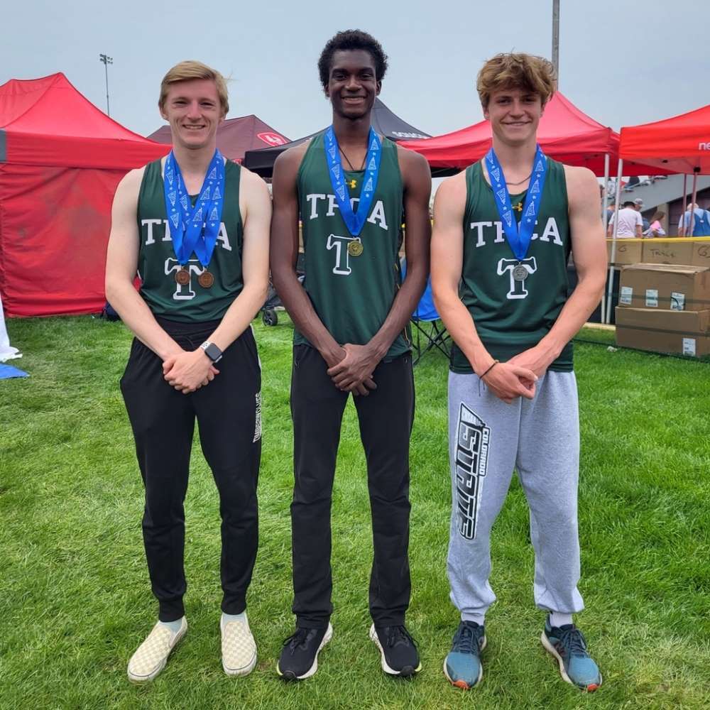 Three Twin Peaks Classical Academy tuition-free charter school track and field athletes standing proudly with medals around their necks
