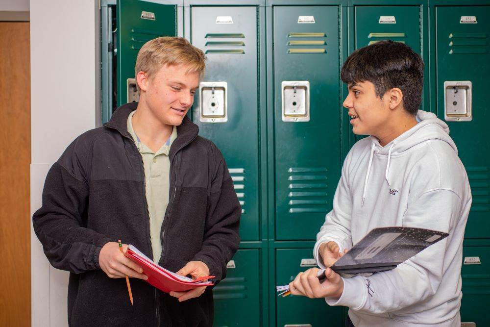 two Twin Peaks Classical Academy charter school students talking in front of lockers