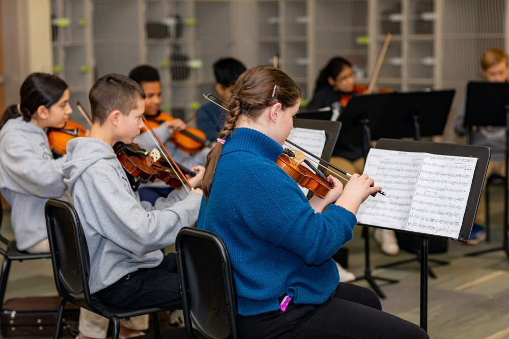 students at Twin Peaks Classical Academy tuition-free charter school play violin in a music class